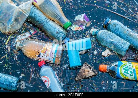 AMSTERDAM, THE NETHERLANDS - MARCH 27, 2017: Plastic waste floating in a canal in Amsterdam, The Netherlands Stock Photo
