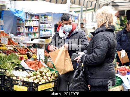 Milan, Italy. 25th Feb, 2020. Milan, CORONAVIRUS in Lombardy. Via Fauchè market - In the photo: people with mask Credit: Independent Photo Agency/Alamy Live News Stock Photo