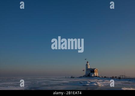 Lighthouse Paard van Marken with drifting ice, Netherlands, Northern Netherlands, Markermeer Stock Photo