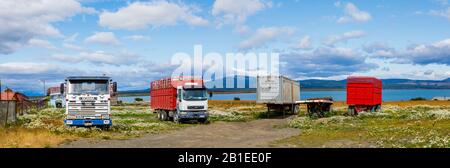 Disused lorries and trailers parked in a field in Puerto Bories, a small village near Puerto Natales, Patagonia , Magallanes Region, southern Chile Stock Photo