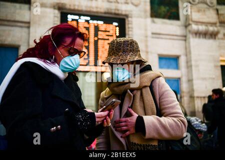 Milan, Italy. 25th Feb, 2020. Passengers at Milano Centrale Train Station wear protective respiratory masks as restrictive movement measures are taken to contain the outbreak of Coronavirus COVID-19 Credit: Piero Cruciatti/Alamy Live News Stock Photo