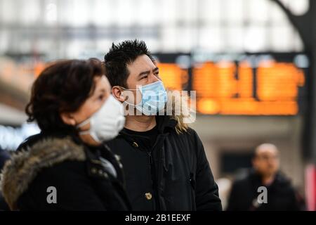 Milan, Italy. 25th Feb, 2020. Passengers at Milano Centrale Train Station wear protective respiratory masks as restrictive movement measures are taken to contain the outbreak of Coronavirus COVID-19 Credit: Piero Cruciatti/Alamy Live News Stock Photo