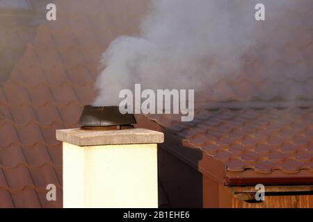Thick smoke coming out of the chimney causing air pollution Stock Photo