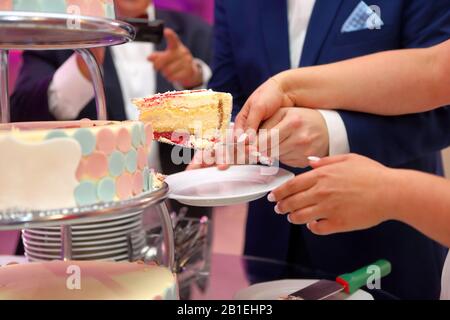 Bride and Groom cutting the wedding cake on the wedding party Stock Photo