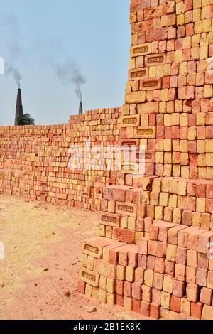 Brick factory where families are making bricks with clay before drying them under the sun and in oven using straws. There is about 25 millions people Stock Photo