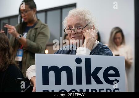 A woman listens as Diana Taylor (not pictured), longtime companion of former New York City mayor and current candidate for the Democratic presidential nomination Michael Bloomberg, speaks to supporters at a Women for Mike rally in downtown Houston. Stock Photo