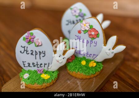 Colorful easter rabbits cookies on wooden background. Festive decoration. Happy Easter. Stock Photo