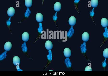 Pattern made of natural blue colored eggs and feather in spermatozoid shape on dark table. Sperm motion, donation concept. Easter background. Trendy blue color, minimal style. Stock Photo