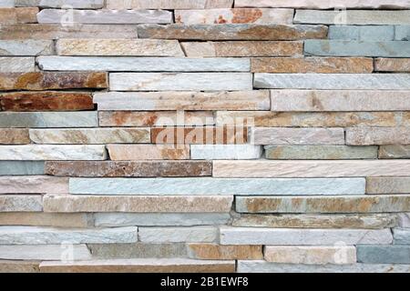 detailed white tan brown rust slim cut slate rock wall close-up Stock Photo