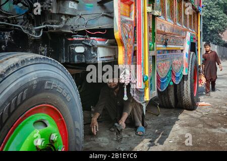 Lahore, Pakistan: Pakistani truck decoration artists. Colorful Jingle trucks maintenance Stock Photo