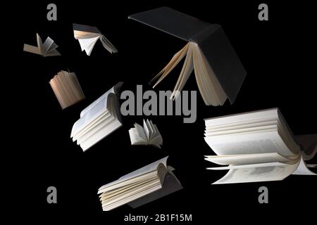 Flying books isolated on black Stock Photo