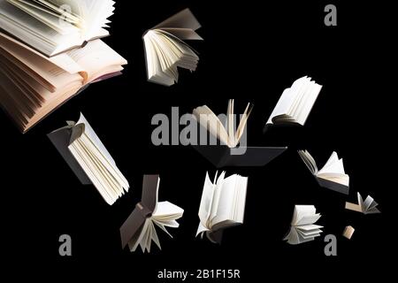 Flying several books isolated on black background. Stock Photo