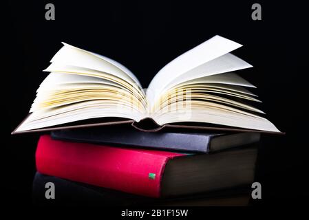 Flying several books isolated on black background. Stock Photo