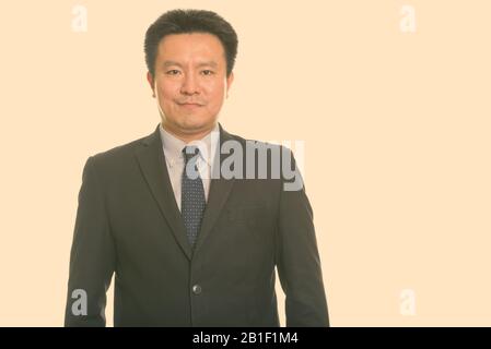 Portrait of mature handsome Japanese businessman in suit Stock Photo