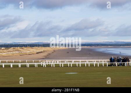 ST ANDREWS, SCOTLAND - 25/2/2020 - A view of west sands from over the Old Course, with an expectant crowd in the frame. Stock Photo