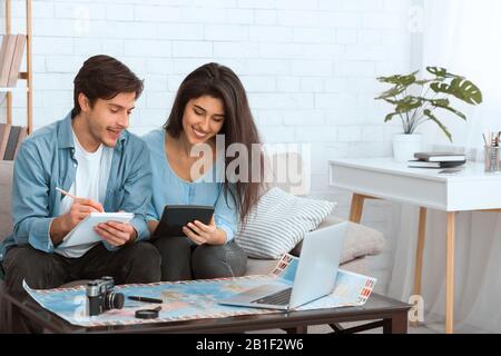 Plan finances. Couple preparing for vacation and calculating expenses Stock Photo