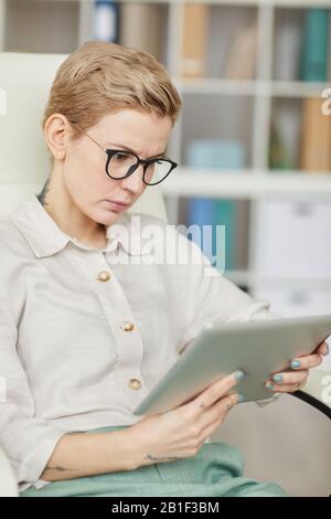 Portrait of successful businesswoman using digital tablet at workplace Stock Photo