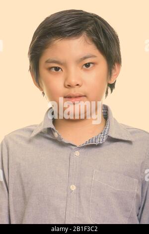 Studio shot of young cute Japanese boy Stock Photo