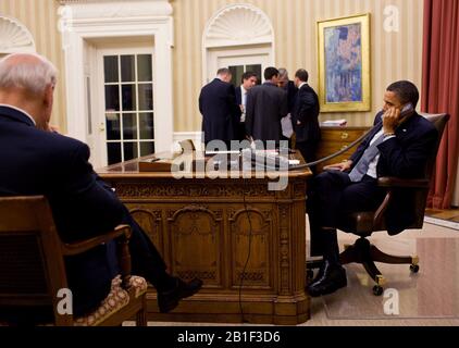 United States President Barack Obama talks on the phone with President Hosni Mubarak of Egypt in the Oval Office,  Friday, January 28, 2011.   U.S. Vice President Joe Biden, left, and the President's National Security team listen in the background.  .Mandatory Credit: Pete Souza - White House via CNP /MediaPunch