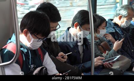Tokyo, Japan. 17th Feb, 2020. Passengers wearing face masks are seen on a trolley bus in Tokyo, Japan, Feb. 17, 2020. TO GO WITH 'Roundup: Japan adopts basic policy to combat novel coronavirus spread' Credit: Guo Wei/Xinhua/Alamy Live News Stock Photo