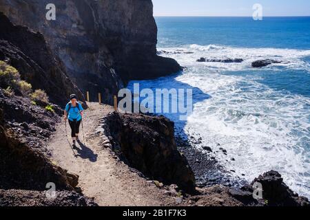 Woman hiking at the Playa de Guarinen, near Taguluche, La Gomera, Canary Islands, Spain Stock Photo