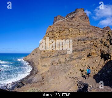 Woman hiking at the Playa de Guarinen, Galion mountains, near Taguluche, La Gomera, Canary Islands, Spain Stock Photo