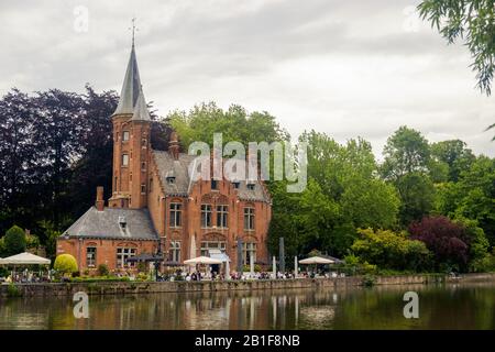 The Minnewater castle lies next to 'love lake' in Bruges. This 19th century building completes the romantic picture of the Minnewater Park. Stock Photo