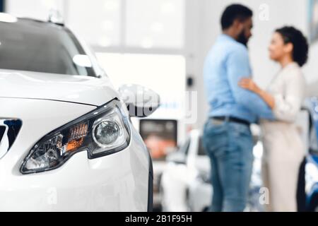 Unrecognizable Couple Hugging Standing Near Auto In Dealership Center Stock Photo
