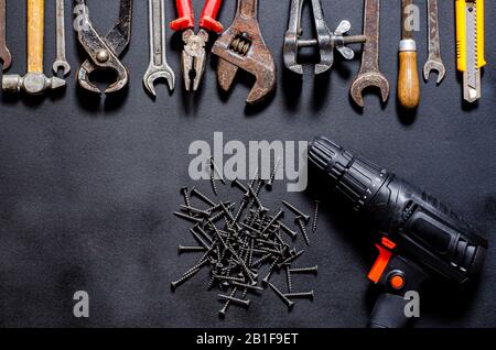 Construction worker tools on a dark background top view. Stock Photo