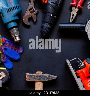 Construction worker tools on a dark background top view. Stock Photo