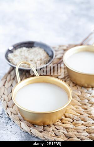 Makgeolli rice wine is one of the oldest korean traditional fermented alcoholic drinks close-up. Healthy asian boozy beverage. Vertical orientation Stock Photo