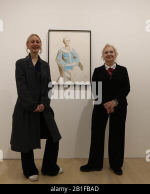 Scarlett Clark and her grandmother Celia Birtwell posing beside Scarletts portrait, as part of an exhibition, David Hockney: Drawing from Life, which runs from 27 February to 29 June at the National Portrait Gallery in London. Stock Photo