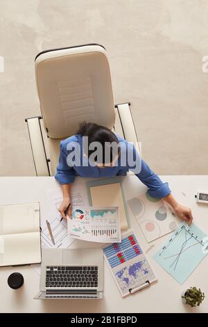 Above view background of businesswoman holding document while sitting at table, copy space Stock Photo
