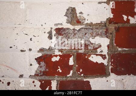 Old brick wall with paint worn away Stock Photo