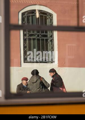 Reflection of older people talking in Venice (Italy), sunny day in winter Stock Photo