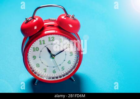 Red alarm clock on the color background. Stock Photo