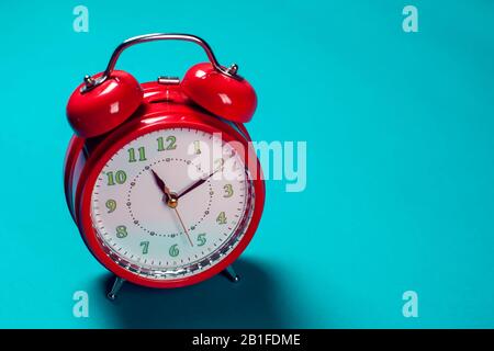 Red alarm clock on the color background. Stock Photo