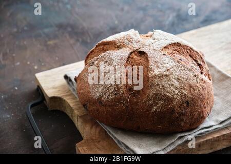 Freshly baked bread on cutting board. Stock Photo
