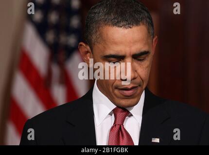 President Barack Obama looks down at the end of a meeting with Senators ...