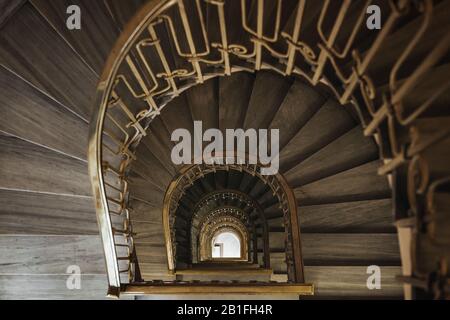 zenithal view of the spiral of a vintage wooden staircase Stock Photo