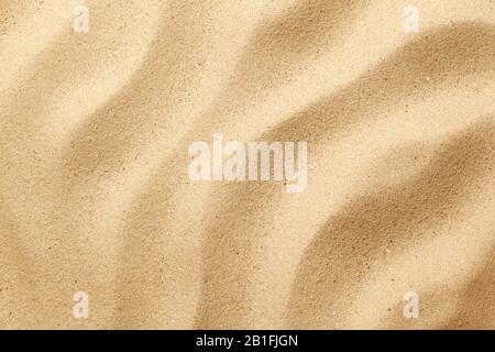 Wavy sand background for summer designs. Flat lay, top view Stock Photo