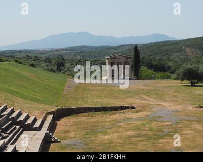 The Heroon Mausoleum and part of the Stadium at Ancient Messene, Ithomi, Messini, Messenia, Greece. Mountains of the Peloponnese in the background. Stock Photo