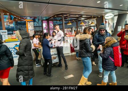 Workers for Häagen-Dazs distribute free Ruby Cacao ice cream bars during a brand activation at their store in the Fulton Center in New York on Friday, February 14, 2020. (© Richard B. Levine) Stock Photo