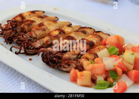 Roast squid (whole) on white platter, Cadiz, Spain. Stock Photo