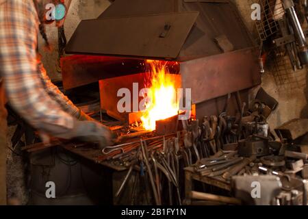Fire of blacksmith in the blacksmith's workshop. Stock Photo