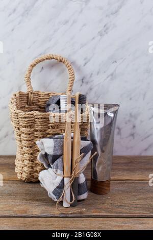 Bamboo toothbrushes and paste on light table Stock Photo