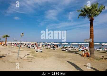 Tourists on the beach at Finikoudes, Larnaca, Cyprus. Stock Photo