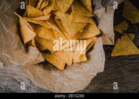 Tortilla chips in craft  bowl on rustic wooden table,  close up Stock Photo