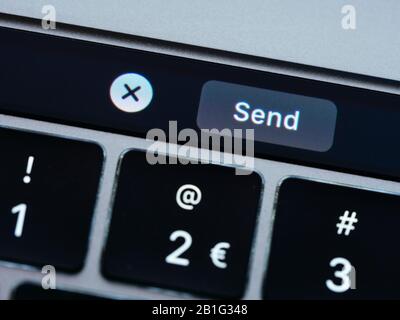 Virtual send button on a laptop to send an email message Stock Photo