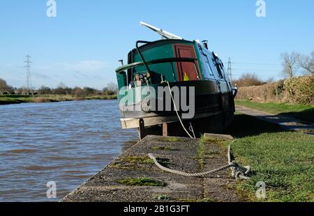 A narrowboat left on the canal bank after flooding during Storm Dennis, February 2020 Stock Photo
